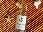 Glass bottle with an anchor label on a textured background