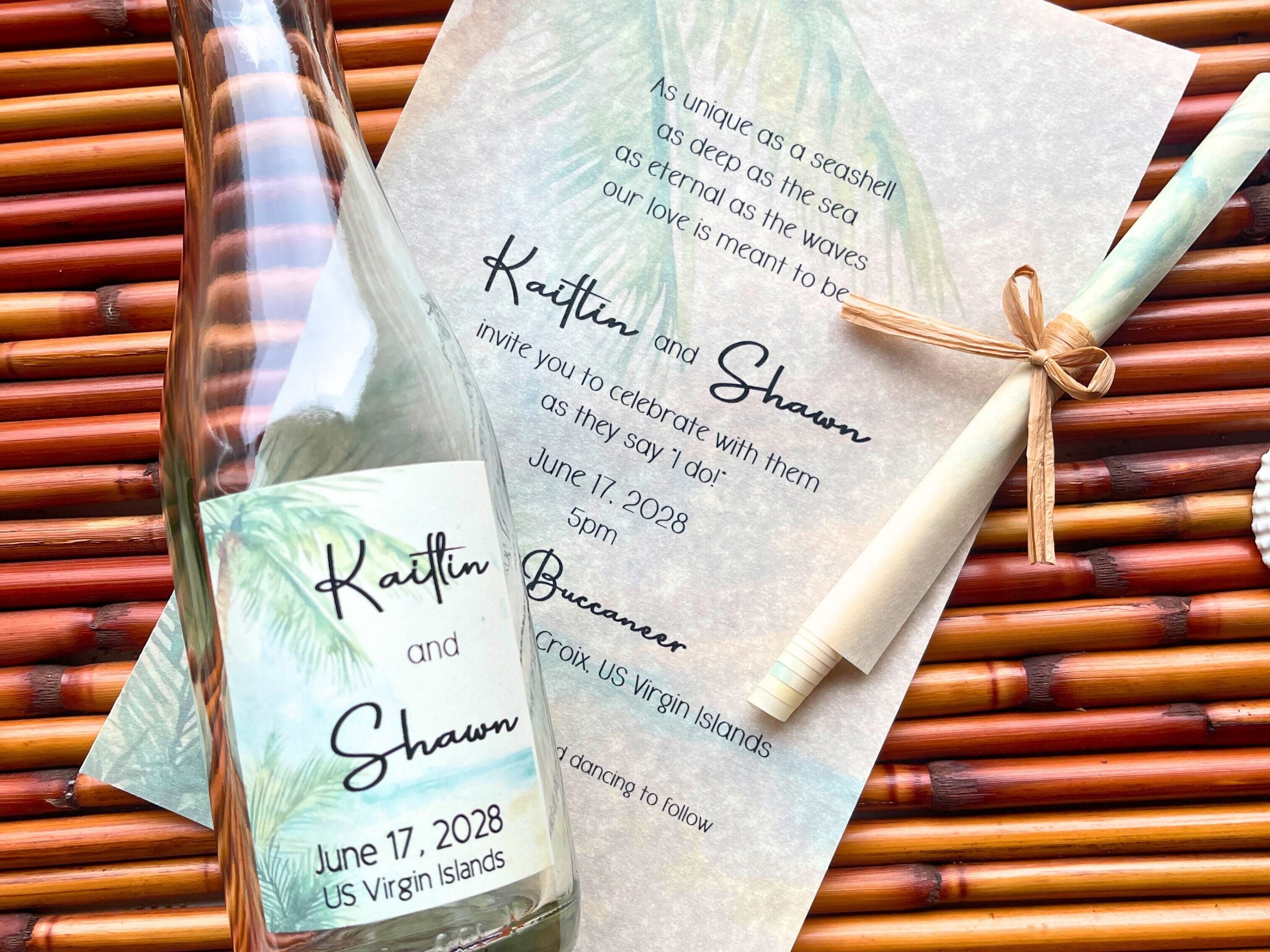 Glass bottle with a wedding invitation attached, set against a bamboo background