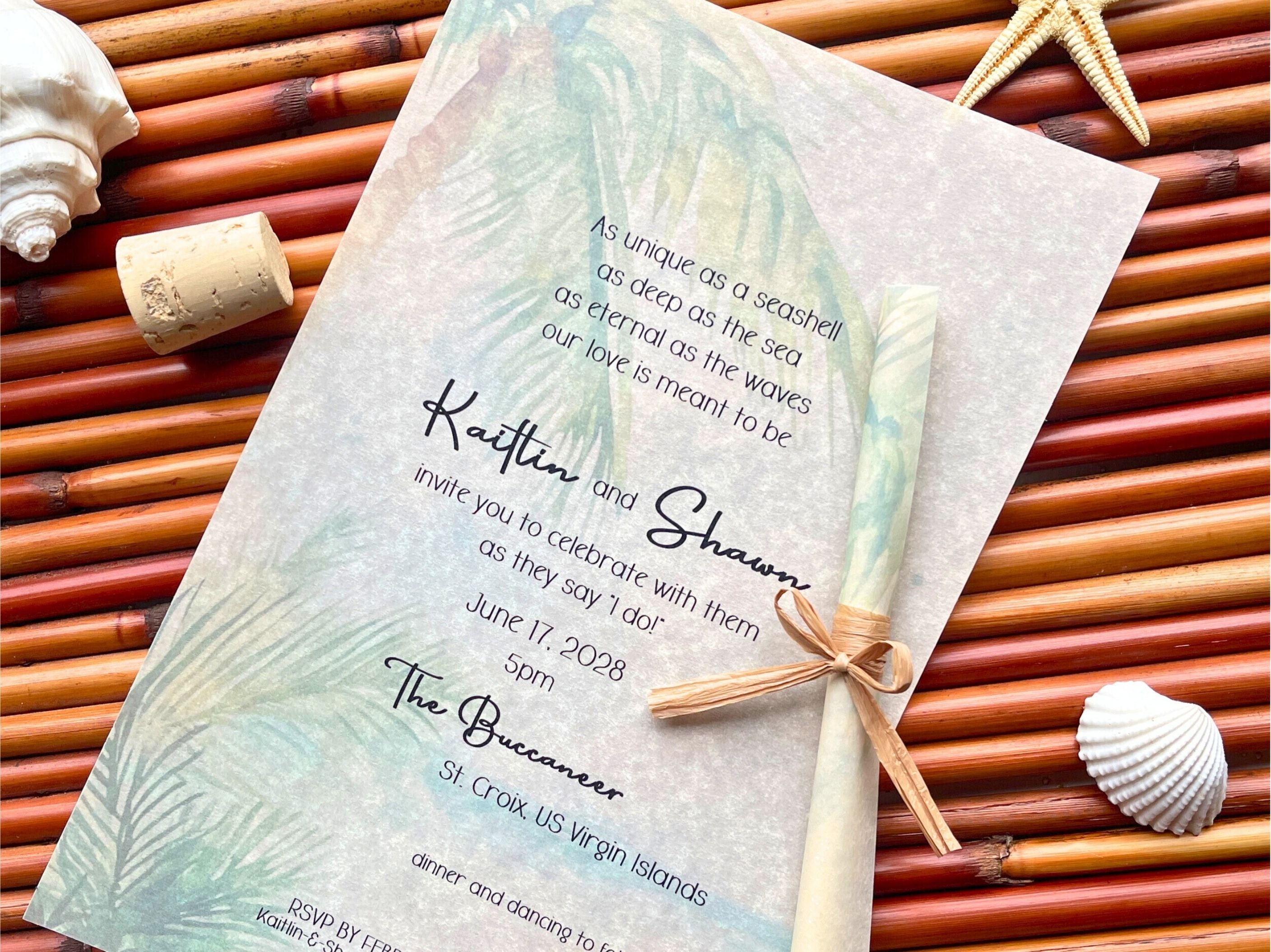 Wedding invitation with tropical design on a woven mat with shells and starfish