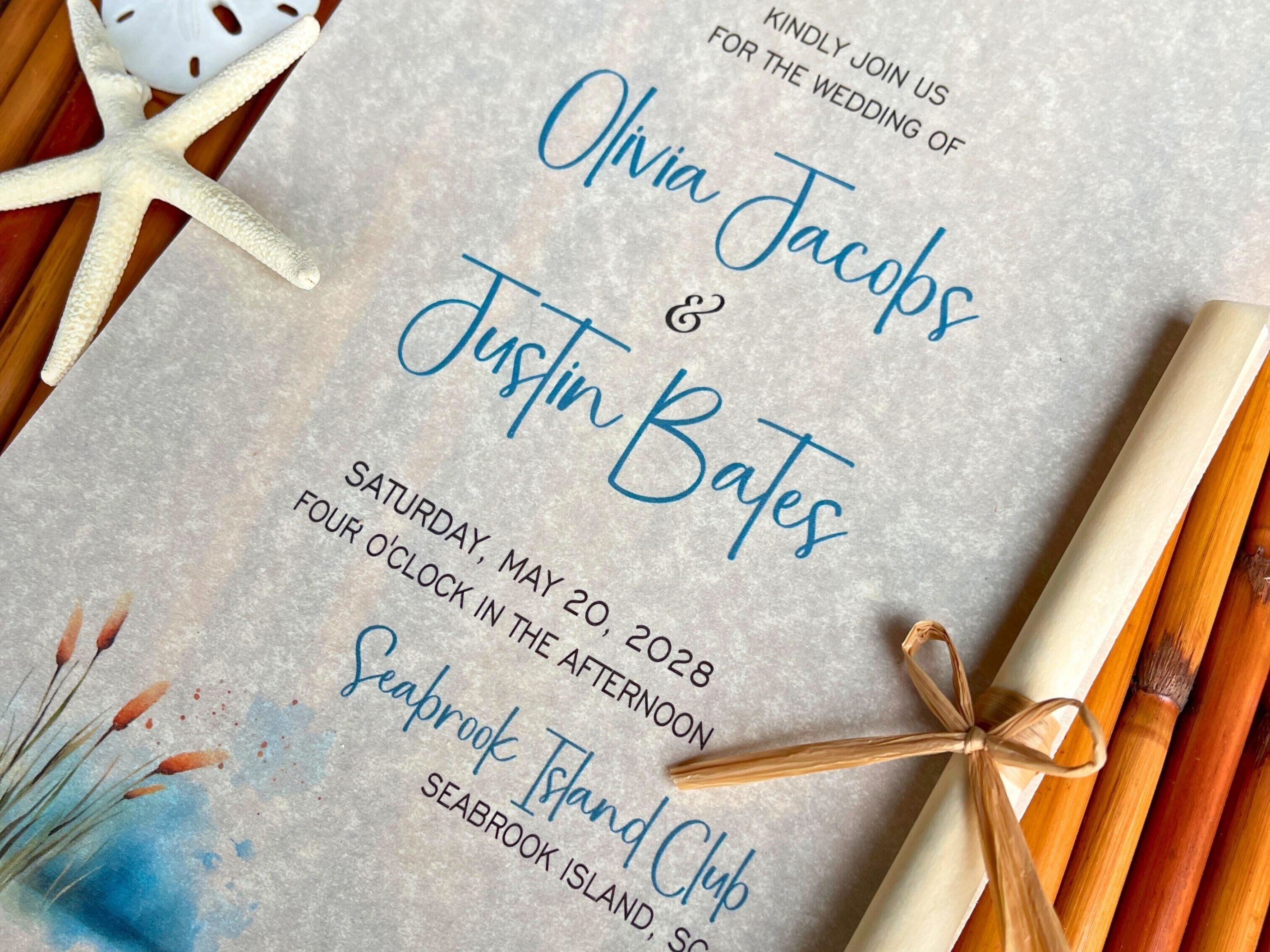 Cattails theme wedding invitation with starfish and rolled paper on a wooden surface