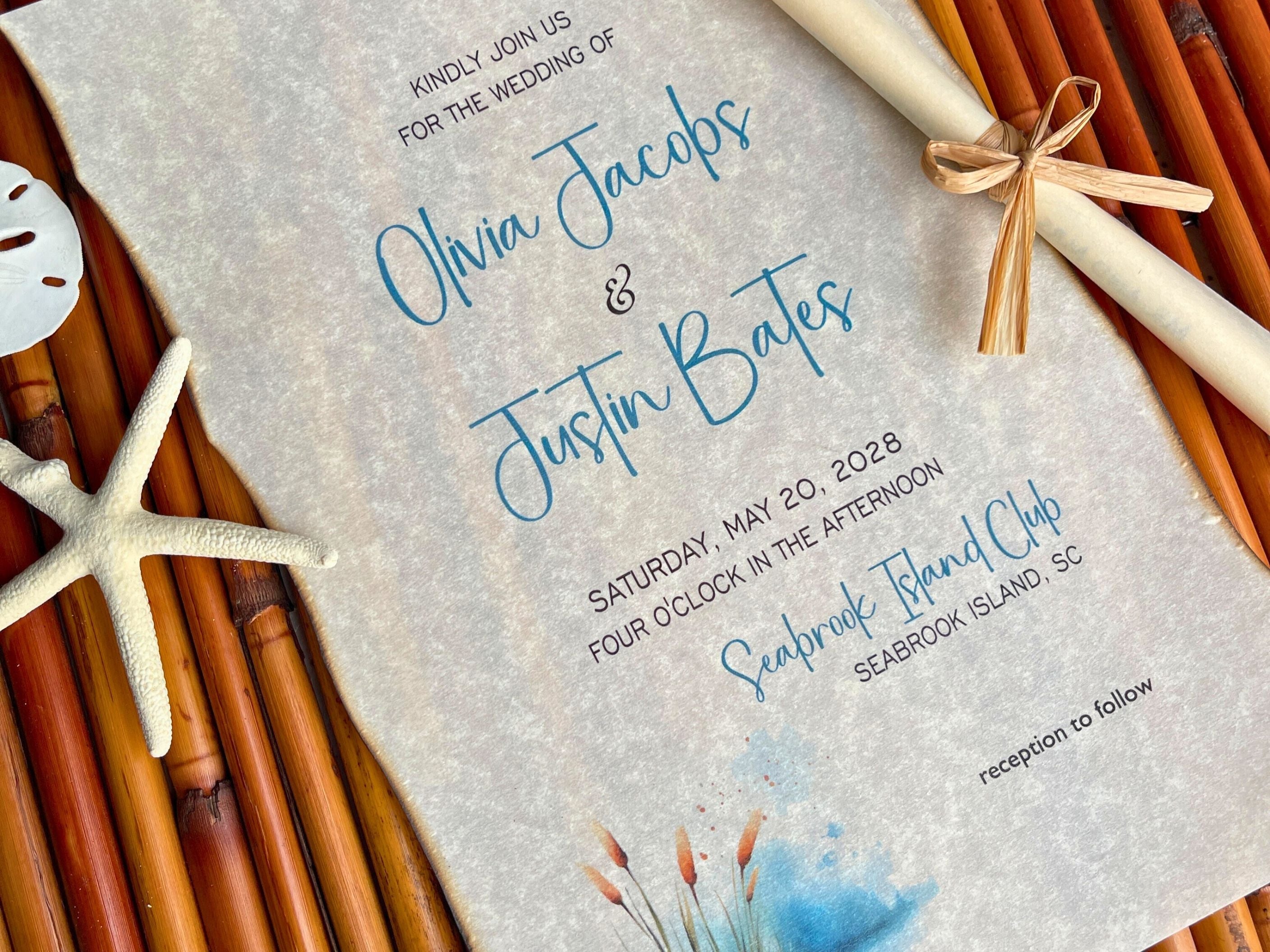 Wedding invitation with beach-themed elements on a textured surface.