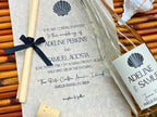Wedding invitation with an elegant seashell design featuring black details for a beach wedding at The Ritz-Carlton, Amelia Island 