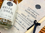 Wedding invitation with a glass bottle on a textured surface