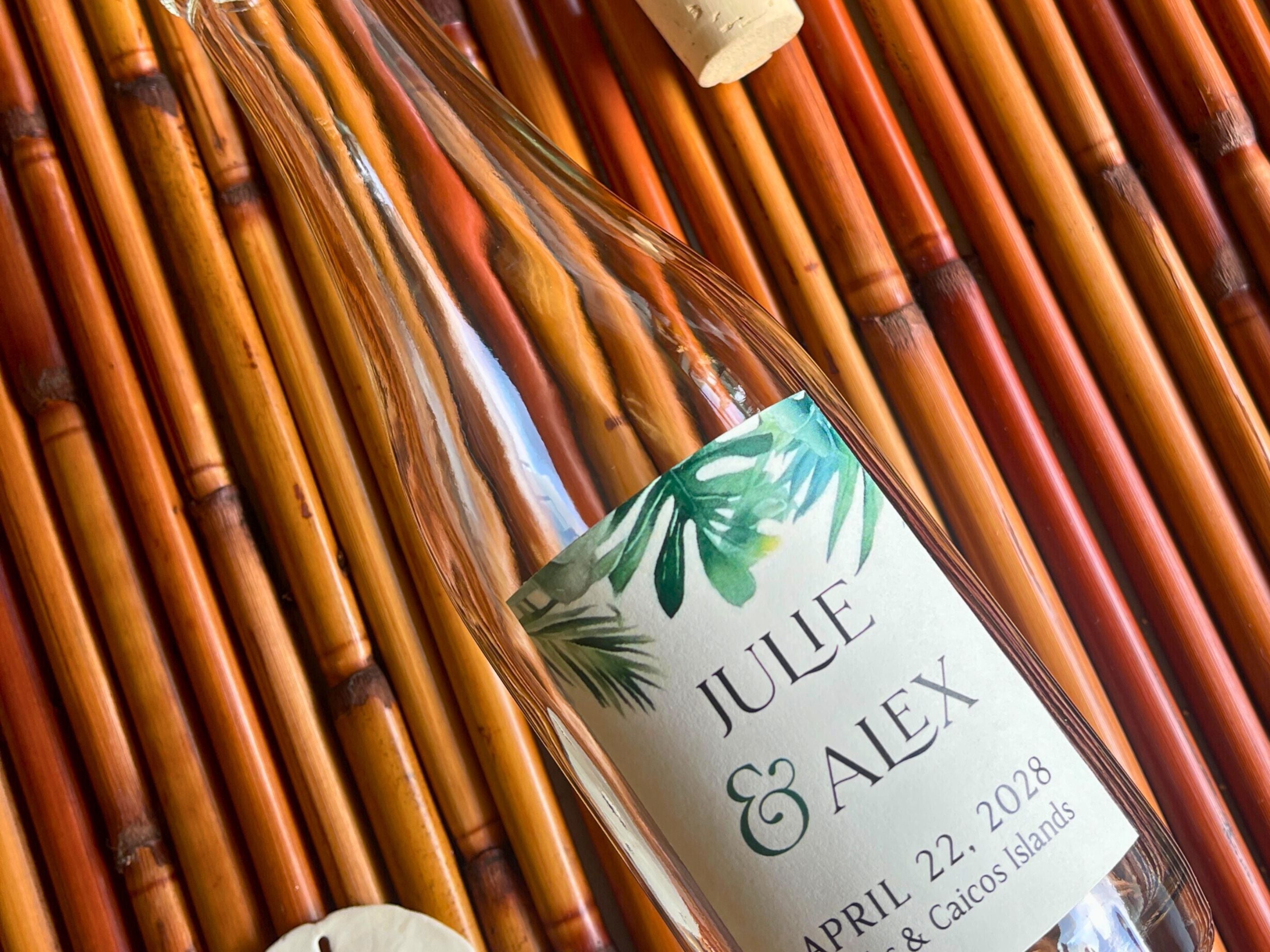 Glass bottle with a personalized label on a bamboo surface