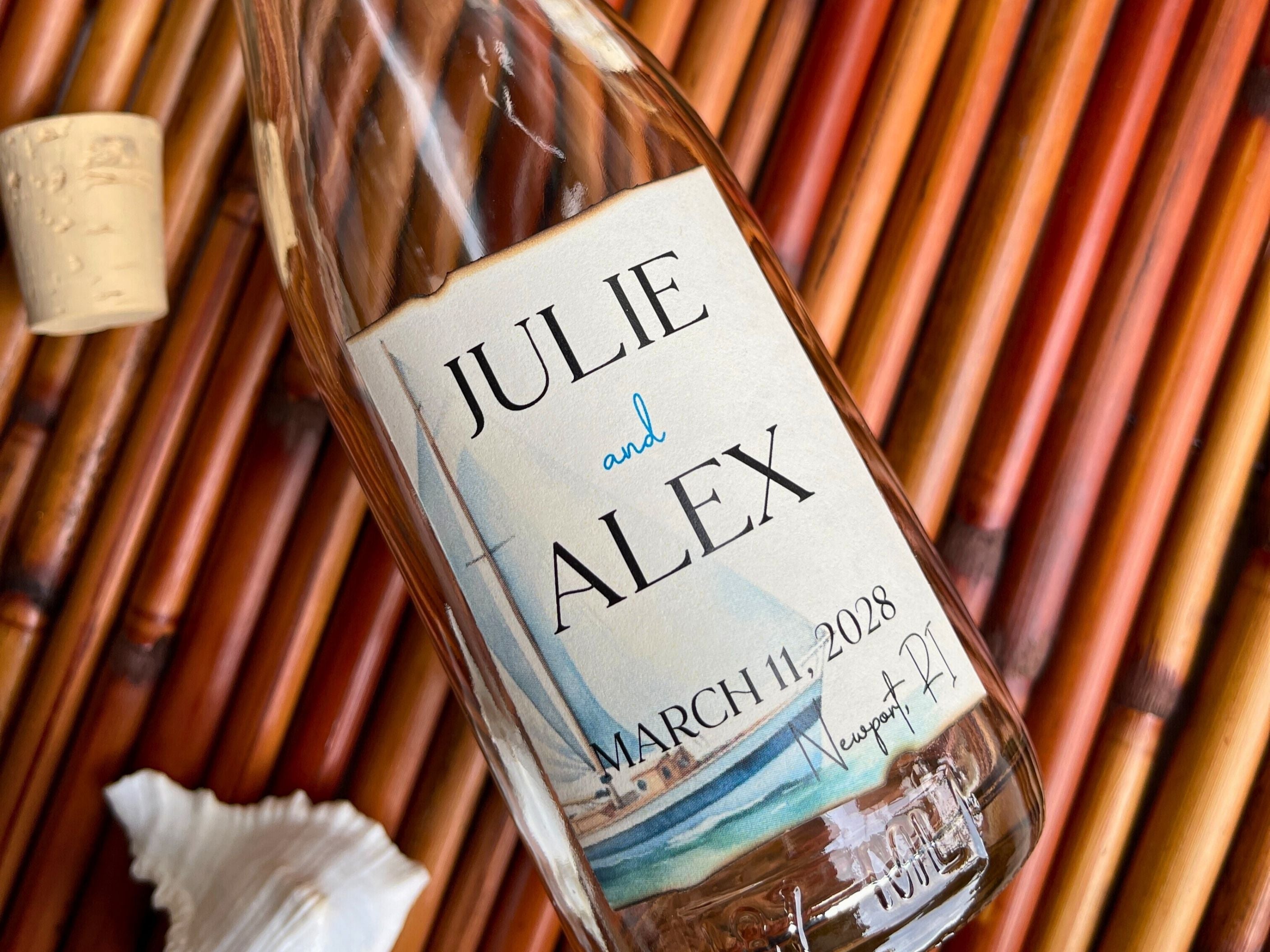 Glass bottle with personalized label on a woven surface.