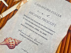 Wedding invitation with shell design on a textured background