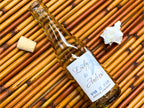 Bottle with a personalized label on a woven mat