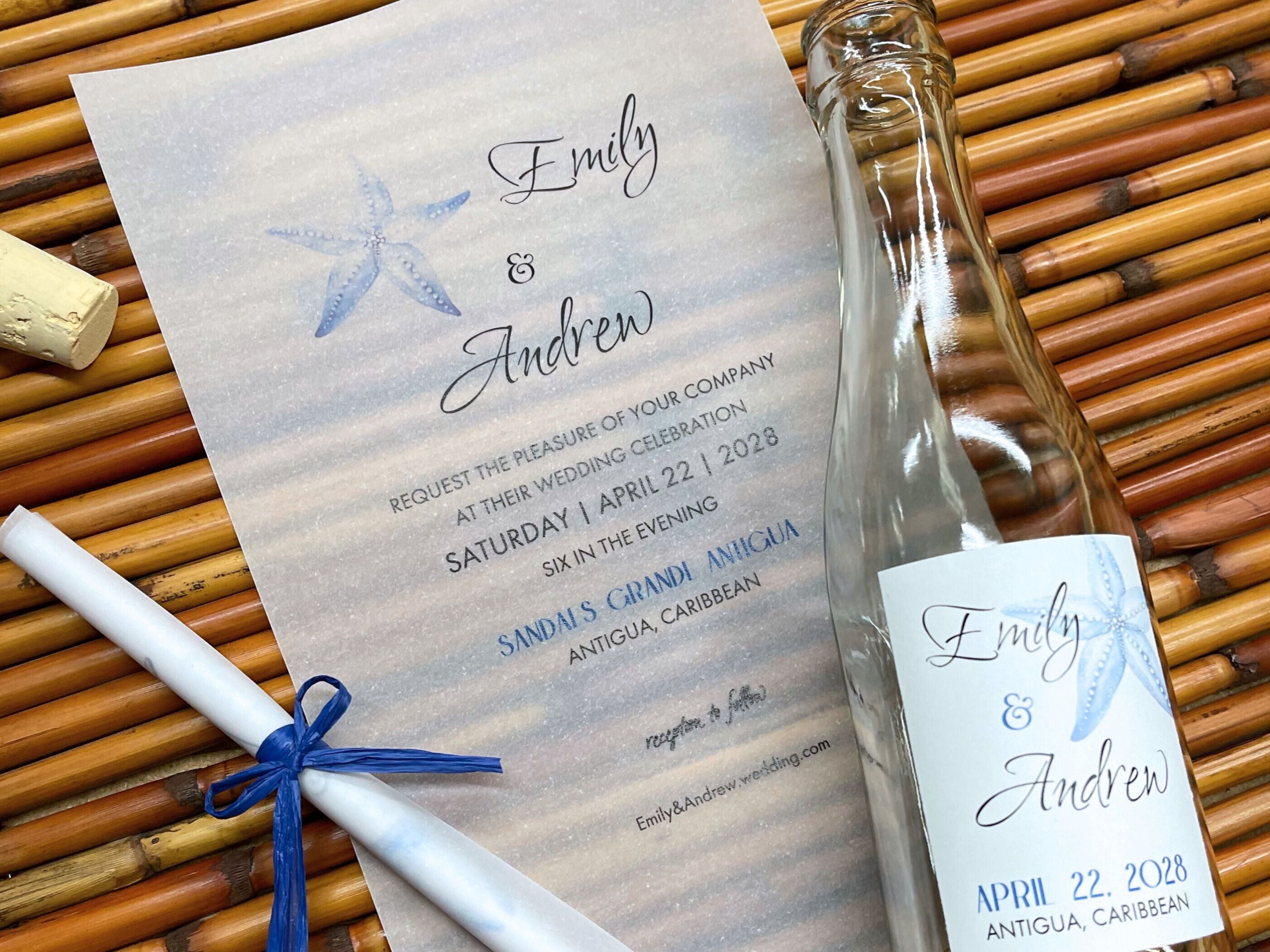 Wedding invitation with starfish design on a woven mat with a bottle and cork.