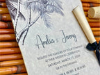 Wedding invitation with palm tree design on a textured surface