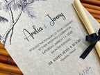 Wedding invitation with black text on a textured surface, featuring a black ribbon and palm tree design.
