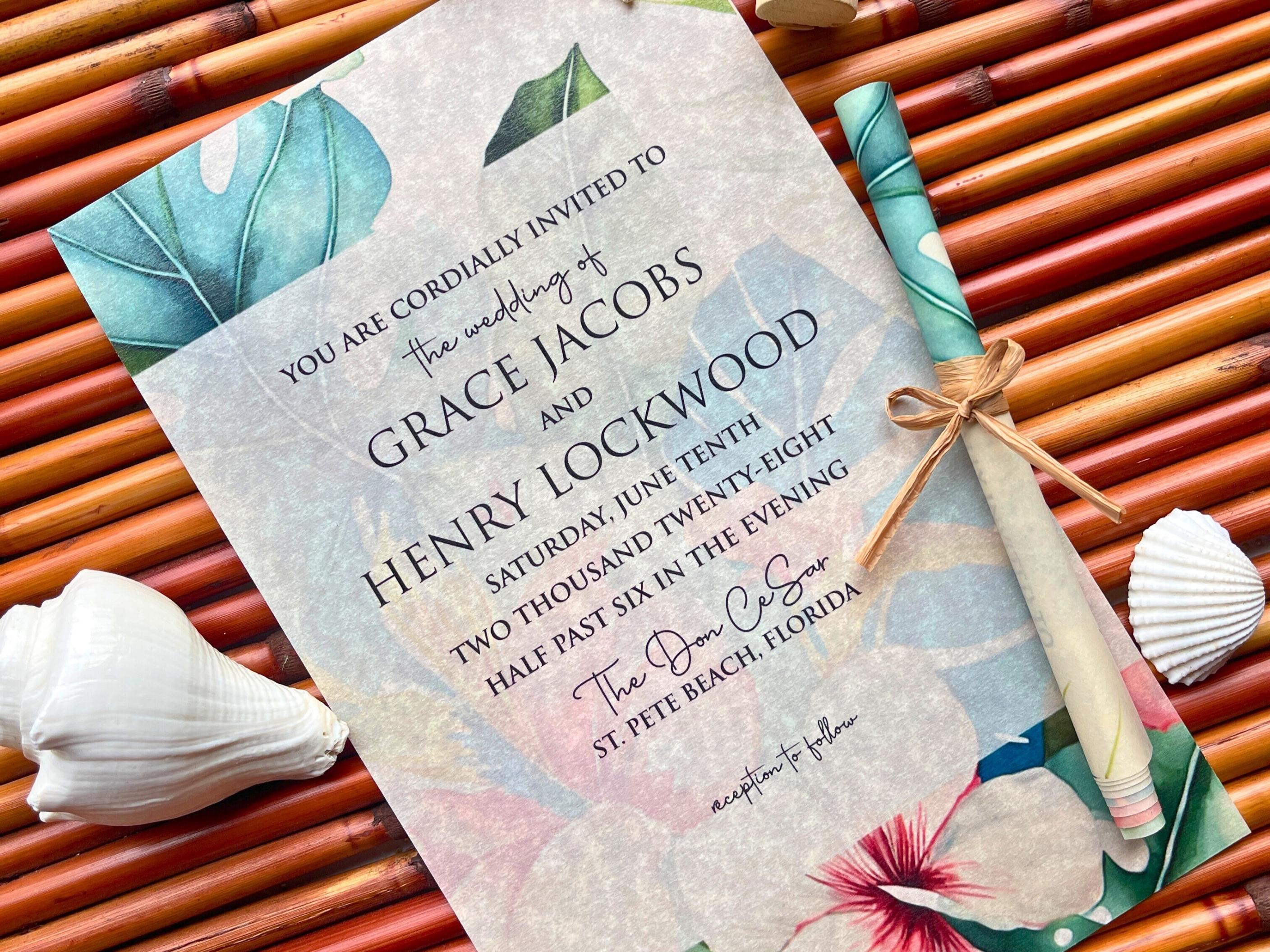 Wedding invitation with tropical design on a background of bamboo sticks and shells