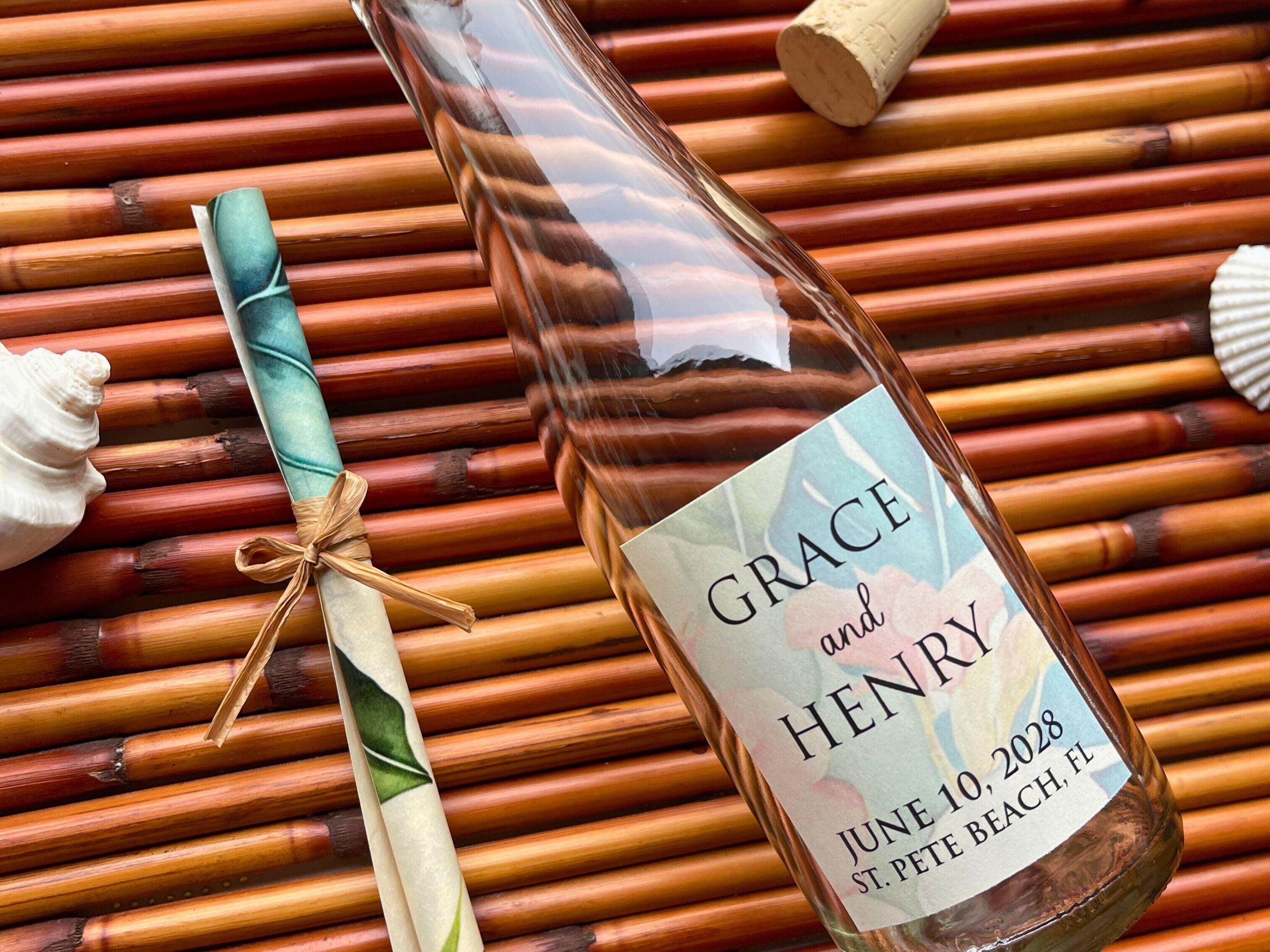 Bottle with an invitation scroll and label on a bamboo surface
