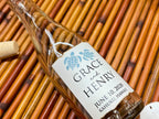 Glass bottle with hand-burnt edges personalized label on a woven mat
