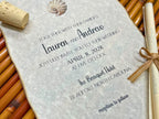 Wedding invitation with seashell design on a textured surface