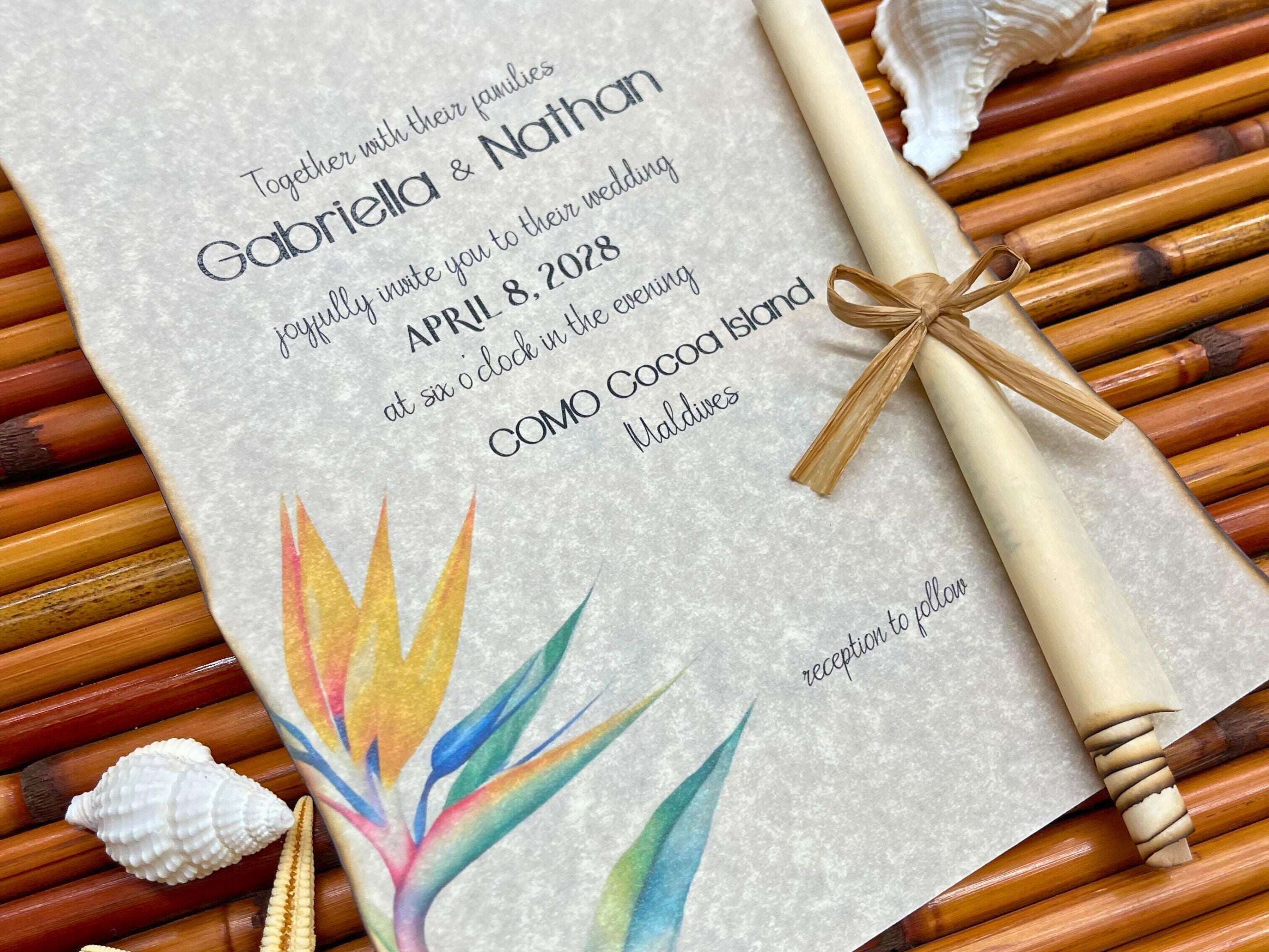 Wedding invitation with tropical bird of paradise design and scroll on a bamboo mat.