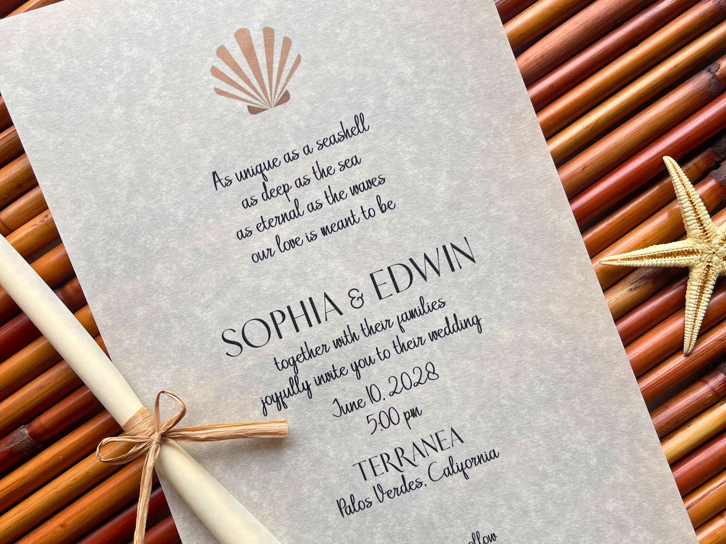 Vellum wedding invitation with shell design on a woven background
